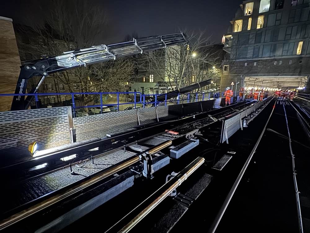 Lorry-mounted crane working over a viaduct during a night possession